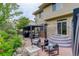 Cozy backyard patio area with comfortable seating, a fire pit, and lush landscaping creating an inviting outdoor space at 5830 Jasper Pointe Cir, Castle Pines, CO 80108