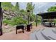 Inviting backyard patio with stylish furniture, heat lamp, and lush landscaping creating a private outdoor retreat at 5830 Jasper Pointe Cir, Castle Pines, CO 80108