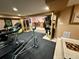 Finished basement with home gym, sauna, and kitchenette for exercise and entertaining at 5830 Jasper Pointe Cir, Castle Pines, CO 80108