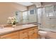 Double vanity bathroom with updated fixtures, a tub, and a glass-enclosed shower at 5830 Jasper Pointe Cir, Castle Pines, CO 80108