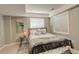 Cozy bedroom featuring a comfortable bed, neutral decor, and ample natural light from the windows at 5830 Jasper Pointe Cir, Castle Pines, CO 80108