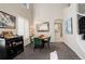 Dining area with tall windows, modern chandelier, and adjacent staircase, seamlessly connects to the kitchen at 5830 Jasper Pointe Cir, Castle Pines, CO 80108