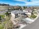 A cream-colored home with manicured landscaping, an attached two-car garage, and a circular tower element at 5830 Jasper Pointe Cir, Castle Pines, CO 80108