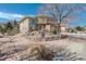 Inviting two-story home with stone accents and a landscaped front yard with decorative rock border at 5830 Jasper Pointe Cir, Castle Pines, CO 80108