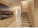 Inviting hallway with neutral colors and a staircase leading to upper level at 5830 Jasper Pointe Cir, Castle Pines, CO 80108