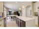 Open kitchen design features a large island with seating and views of the adjacent dining and living areas at 5830 Jasper Pointe Cir, Castle Pines, CO 80108