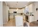Well-lit kitchen featuring white cabinetry, stainless steel appliances, and a spacious central island at 5830 Jasper Pointe Cir, Castle Pines, CO 80108