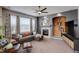 Inviting living room features a modern ceiling fan and an elegant fireplace with a decorative mantle at 5830 Jasper Pointe Cir, Castle Pines, CO 80108