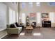 Inviting living room featuring high ceilings, ample natural light, modern decor, and comfortable seating at 5830 Jasper Pointe Cir, Castle Pines, CO 80108