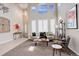 Bright living room with tall windows, stylish decor, a comfortable seating area, and an inviting atmosphere at 5830 Jasper Pointe Cir, Castle Pines, CO 80108