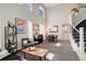 Spacious living room features high ceilings, plentiful natural light, elegant decor, and a staircase at 5830 Jasper Pointe Cir, Castle Pines, CO 80108
