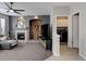 Open living room includes a fireplace and flows into the laundry room at 5830 Jasper Pointe Cir, Castle Pines, CO 80108