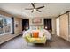 Spacious bedroom featuring large windows, a ceiling fan, and an adjacent barn door to ensuite at 5830 Jasper Pointe Cir, Castle Pines, CO 80108