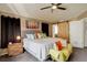 Comfortable bedroom features a ceiling fan, artwork, and a sliding barn door at 5830 Jasper Pointe Cir, Castle Pines, CO 80108