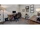 Cozy home office features a dark wood desk, modern computer setup, and decorative wall art at 5830 Jasper Pointe Cir, Castle Pines, CO 80108