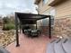 Relaxing outdoor patio with a modern pergola, comfortable seating, and a built-in grill at 5830 Jasper Pointe Cir, Castle Pines, CO 80108