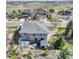 A home's rear exterior with patio area, lush landscaping, and an outdoor seating area at 5830 Jasper Pointe Cir, Castle Pines, CO 80108