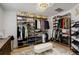 Custom walk-in closet with shelving, drawers, and ample storage space for clothes and shoes at 5830 Jasper Pointe Cir, Castle Pines, CO 80108