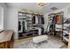 Spacious walk-in closet with custom shelving, wooden floors, and ample storage space at 5830 Jasper Pointe Cir, Castle Pines, CO 80108