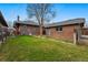 Spacious backyard with lush lawn and brick detached garage, creating a serene outdoor space at 618 Adams St, Denver, CO 80206