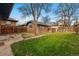Backyard with brick detached garage and small grassy area, perfect for outdoor enjoyment at 618 Adams St, Denver, CO 80206