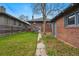 Lush backyard with brick detached garage and walkway, offering a charming outdoor space at 618 Adams St, Denver, CO 80206