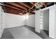 Unfinished basement featuring open ceiling, painted concrete floor, and closet with built-in shelves at 618 Adams St, Denver, CO 80206