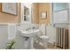 Classic bathroom with a pedestal sink, white fixtures, and vintage-inspired tile flooring at 618 Adams St, Denver, CO 80206