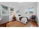 Bright bedroom with hardwood floors, white walls, and natural light from two windows at 618 Adams St, Denver, CO 80206