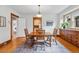 Traditional dining room with wood floors, a large window, and classic wood trim details at 618 Adams St, Denver, CO 80206