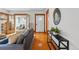 Hallway featuring hardwood floors, console table, and sunroom access at 618 Adams St, Denver, CO 80206