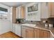 Kitchen featuring light wood cabinets, white appliances and hardwood floors at 618 Adams St, Denver, CO 80206