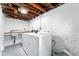 Laundry area in the basement, featuring sink, washer, and dryer at 618 Adams St, Denver, CO 80206