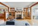Cozy living room with a fireplace, built-in bookshelves, and hardwood floors at 618 Adams St, Denver, CO 80206