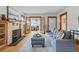 Cozy living room with fireplace, hardwood floors, and sunroom access at 618 Adams St, Denver, CO 80206