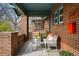 Inviting front porch with seating, brick columns, and charming architectural details at 618 Adams St, Denver, CO 80206