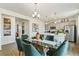 Modern dining area with glass table and green chairs, open to kitchen at 6531 13Th St, Frederick, CO 80530