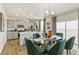 Kitchen and dining area with a glass table and green chairs at 6531 13Th St, Frederick, CO 80530