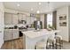 Modern kitchen with gray cabinets and a large kitchen island at 6531 13Th St, Frederick, CO 80530