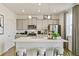 Modern kitchen with gray cabinets, white countertops, and island at 6531 13Th St, Frederick, CO 80530