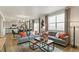 Open living area with gray sofa, coffee table, and large windows at 6531 13Th St, Frederick, CO 80530