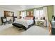 Relaxing main bedroom with two armchairs and large windows at 6531 13Th St, Frederick, CO 80530