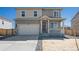 Two-story house with attached garage and front porch at 6531 13Th St, Frederick, CO 80530