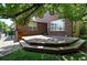 Multi-tiered backyard deck with lush green lawn and mature trees, ideal for outdoor enjoyment at 7527 E Severn Pl, Denver, CO 80230
