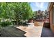 Wooden deck in backyard surrounded by greenery, offering an outdoor entertainment space at 7527 E Severn Pl, Denver, CO 80230