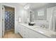Bathroom featuring dual sinks, quartz countertop, and a shower/tub combination at 7527 E Severn Pl, Denver, CO 80230