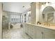 Bright bathroom with dual vanities, a soaking tub, marble accents, and a separate shower at 7527 E Severn Pl, Denver, CO 80230