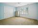 Light-filled bedroom with a closet and large window featuring plantation shutters at 7527 E Severn Pl, Denver, CO 80230
