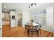 Bright dining area features wood floors, modern lighting, and a view of the laundry room at 7527 E Severn Pl, Denver, CO 80230