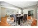 Open dining area with access to both the living room and kitchen, complete with hardwood floors at 7527 E Severn Pl, Denver, CO 80230